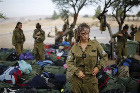 An Israeli Soldier Of The Caracal Battalion Stands Next To Backpacks