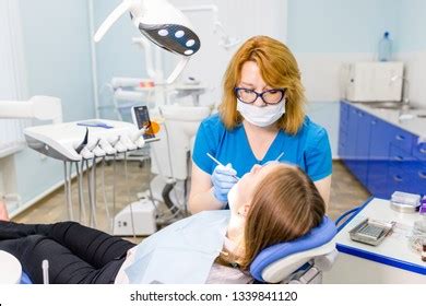 Female Dentist Blue Uniform Cure Tooth Stock Photo 1339841120